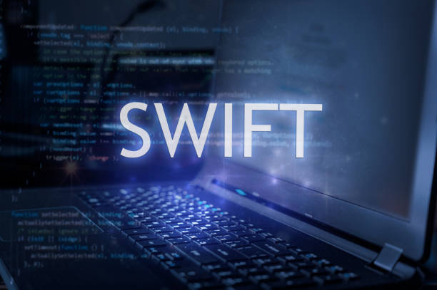 Swift inscription against laptop and code background. Learn swift programming language, computer courses, training.