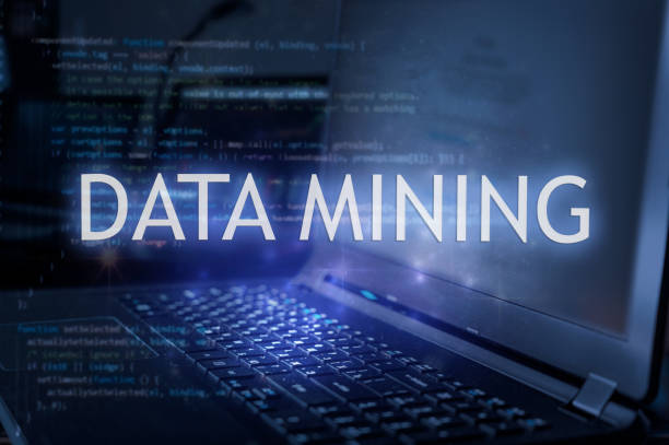 Data mining inscription against laptop and code background.