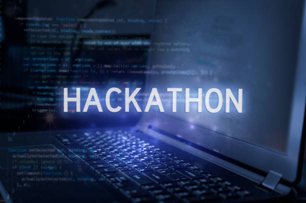 Hackathon inscription against laptop and code background. Technology concept.