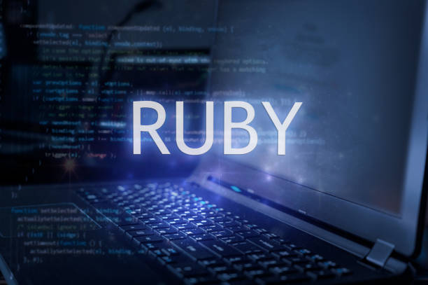 Ruby inscription against laptop and code background. Learn ruby programming language, computer courses, training.